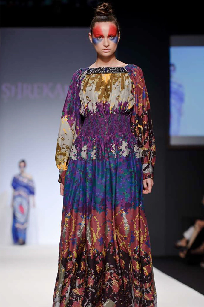 Dynamism and Movement of futurist painting, Dancing lady inspired pixel print with Swarovski crystalized pearls on a luxury smocked kaftan that was shown in Dubai fashion week