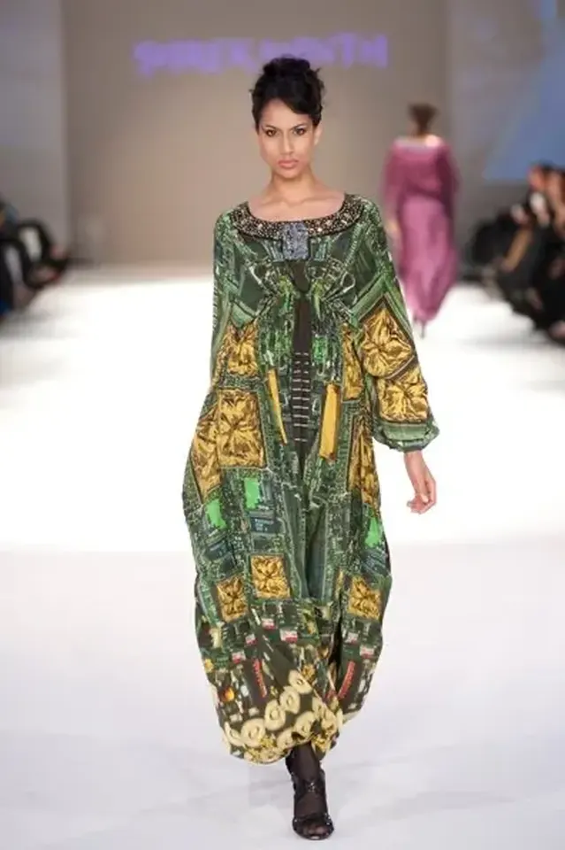 Model wearing a silk designer kaftans with a Blackberry motherboard print and Swarovski crystal and pearl embroidery on the neckline, featuring actual motherboard details to show omani fashion