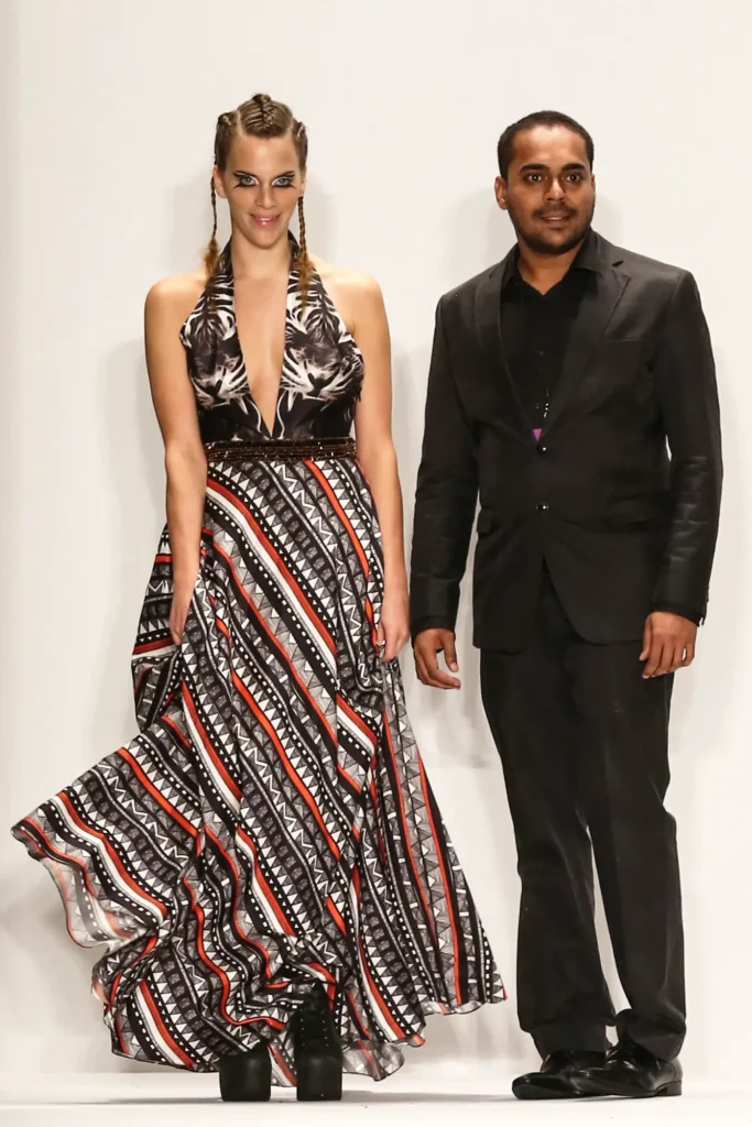 Srikanth Yeddula founder of sustainable fashion brand, Shrekahnth and Juliette Dechy bowing on the runway after the Spring/Summer 2015 collection showcase at New York Fashion Week.